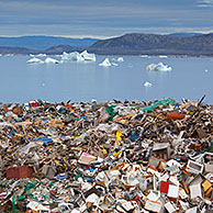 Rubbish at garbage dump and icebergs at Ilulissat / Jakobshavn, Disko-Bay, Greenland